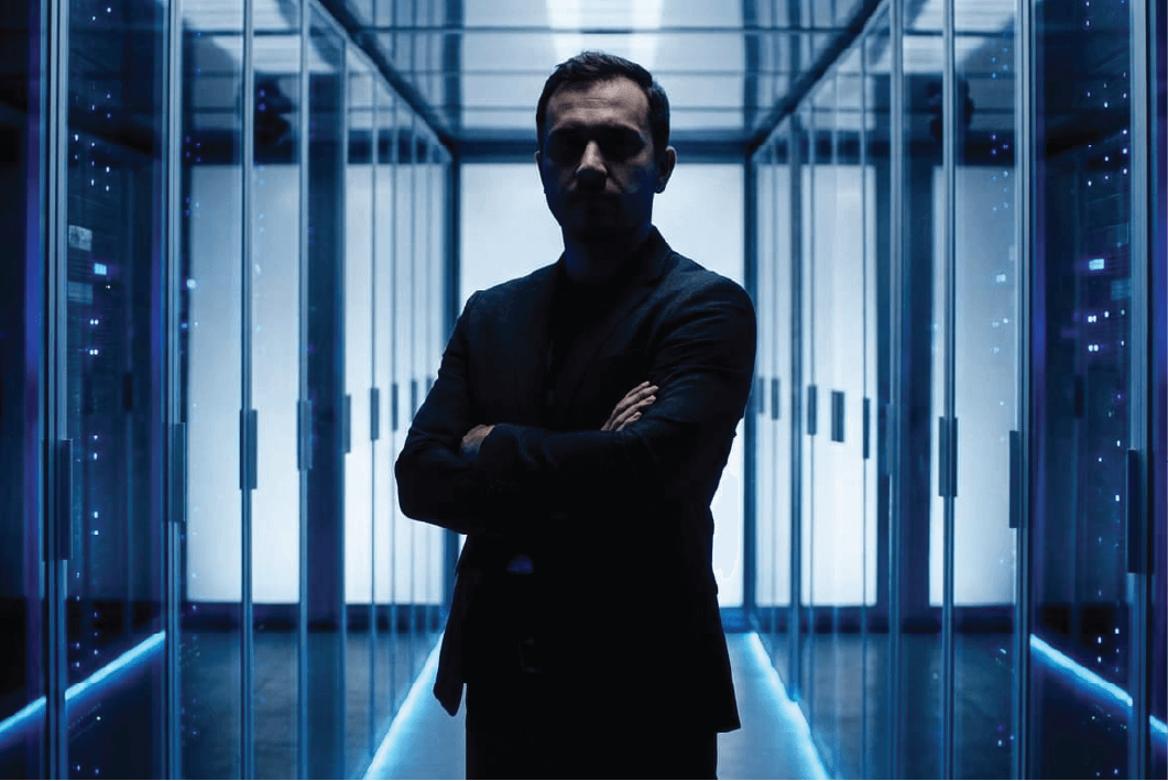 Security specialist standing in a data center corridor